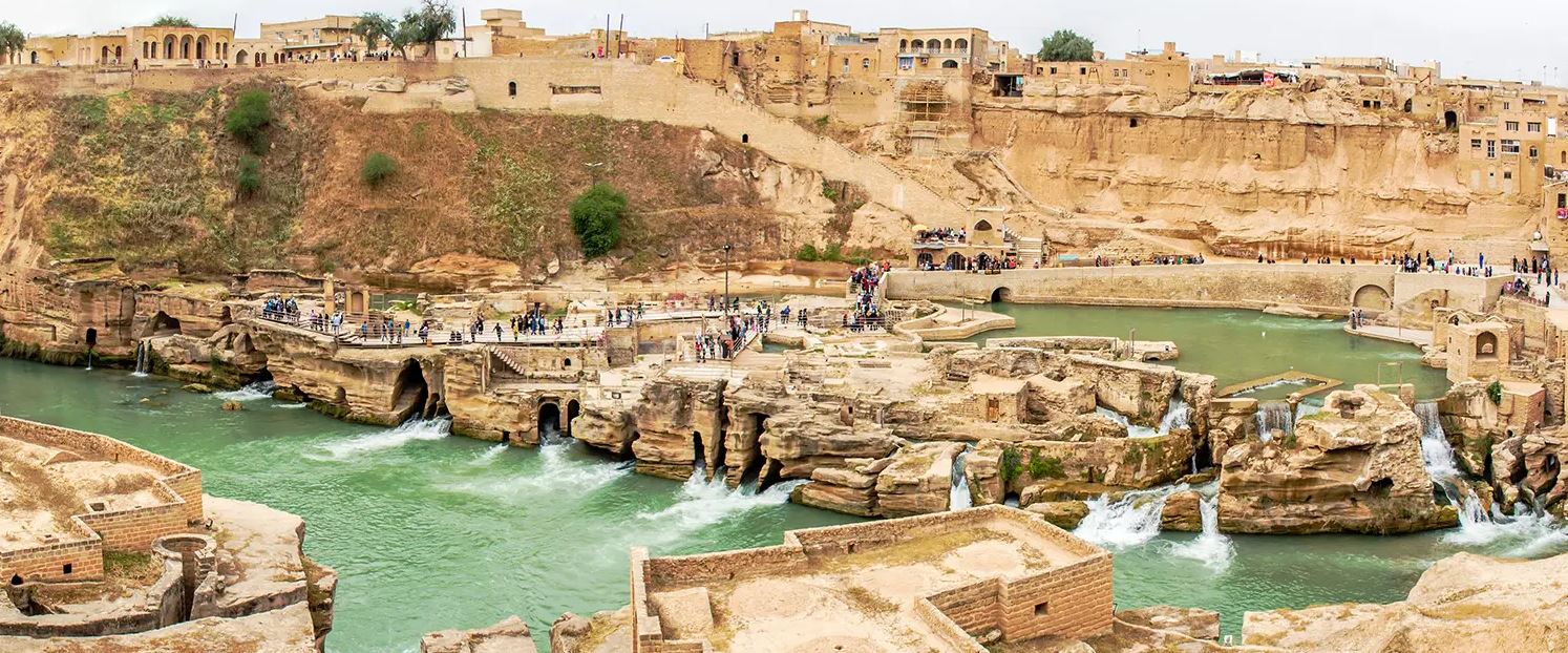Shushtar, Historical Hydraulic System, inscribed as a masterpiece of creative genius, can be traced back to Darius the Great in the 5th century B.C. It involved the creation of two main diversion canals on the river Kârun one of which, Gargar canal, is still in use providing water to the city of Shushtar via a series of tunnels that supply water to mills. It forms a spectacular cliff from which water cascades into a downstream basin. It then enters the plain situated south of the city where it has enabled the planting of orchards and farming over an area of 40,000 ha. known as Mianâb (Paradise). The property has an ensemble of remarkable sites including the Salâsel Castel, the operation centre of the entire hydraulic system, the tower where the water level is measured, damns, bridges, basins and mills. It bears witness to the know-how of the Elamites and Mesopotamians as well as more recent Nabatean expertise and Roman building influence.